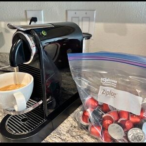Nespresso Black Coffee Machine with Red Capsules